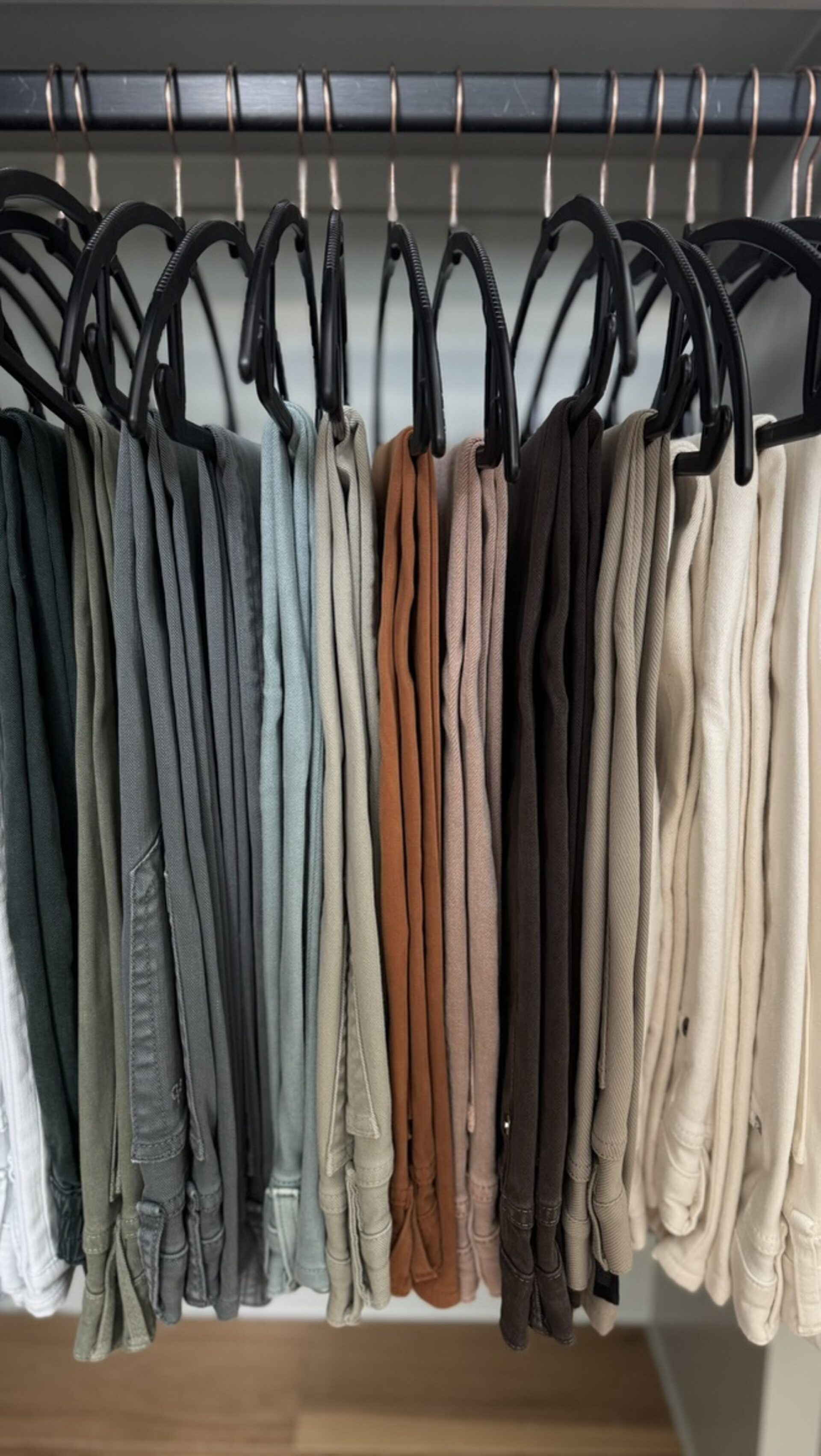 Organized closet with neatly folded garments on hangers